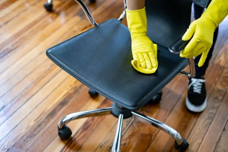 Cleaning office chair with yellow gloves